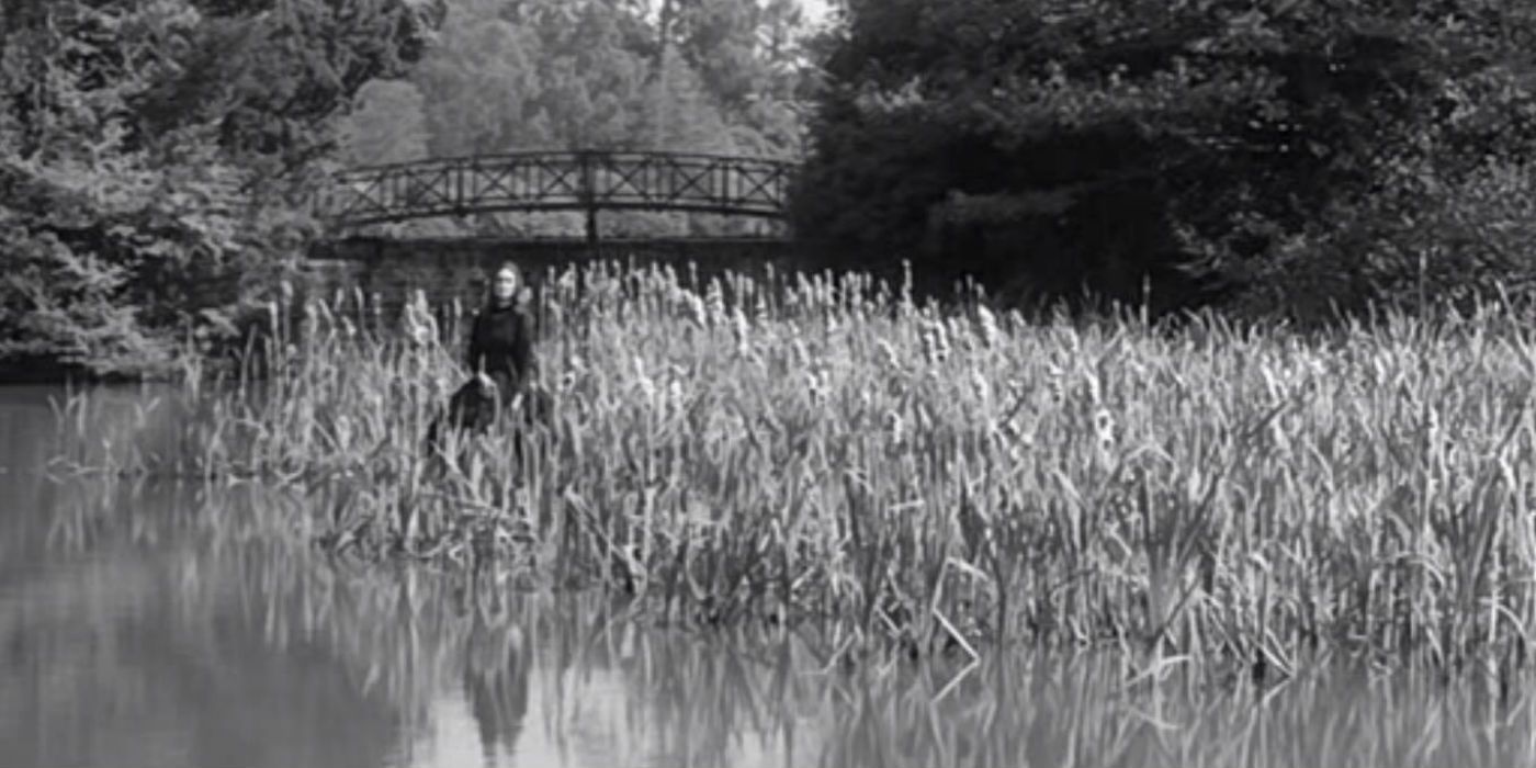 A woman in a field by a river in The Innocents (1961)