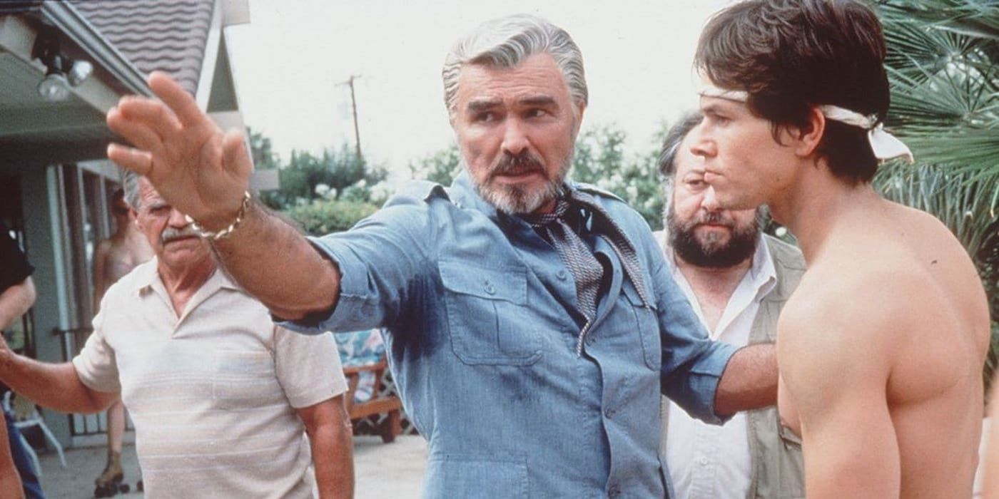 Burt Reynolds and Mark Wahlberg and Ricky Jay in Boogie Nights