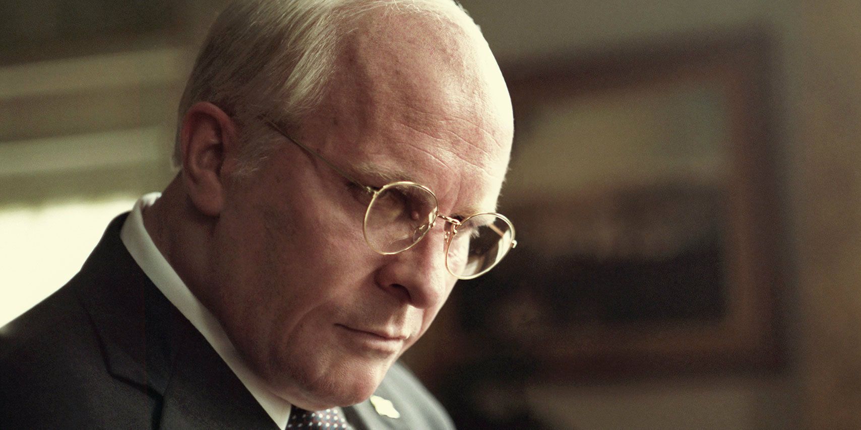 Christian Bale as Dick Cheney angrily staring ahead in Vice.