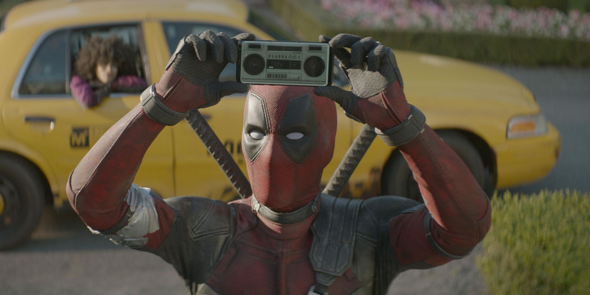 Deadpool holds up an iPhone with a stereo app in Deadpool 2
