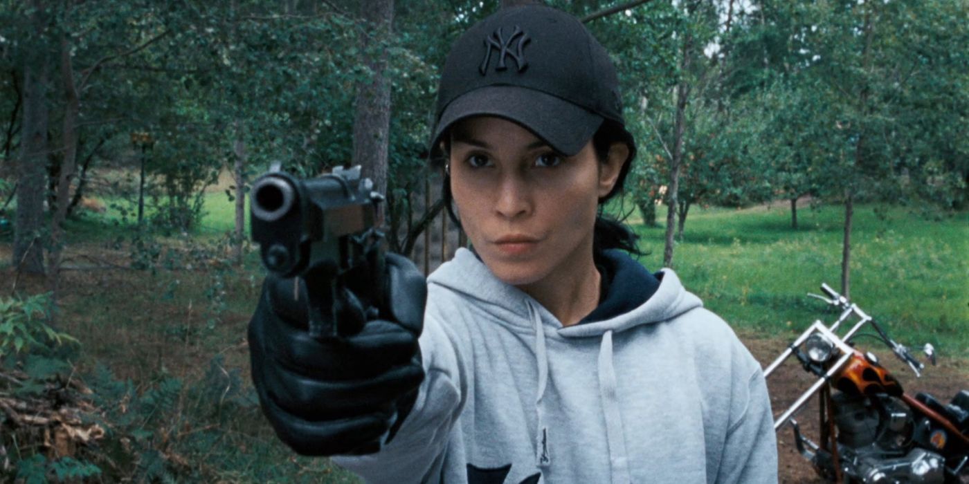 Lisbeth Salander pointing a gun at someone in The Girl Who Played With Fire