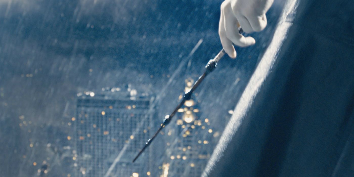 Grindelwald's hand holding the Elder Wand in the rain in Harry Potter.