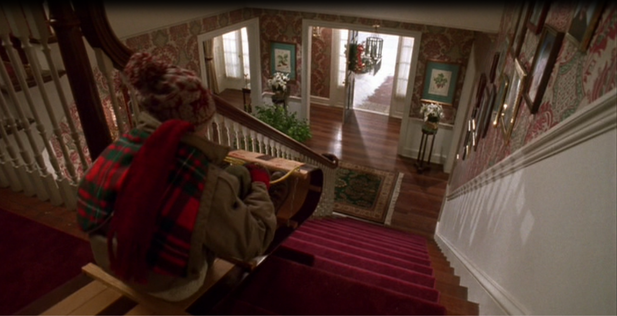 Kevin rides down the stairs in Home Alone