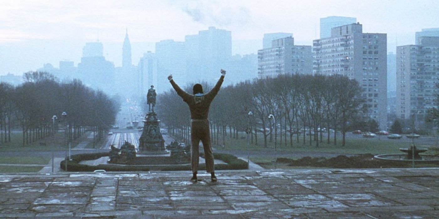 Sylvester Stallone standing at the top of the Art Museum steps in Rocky.
