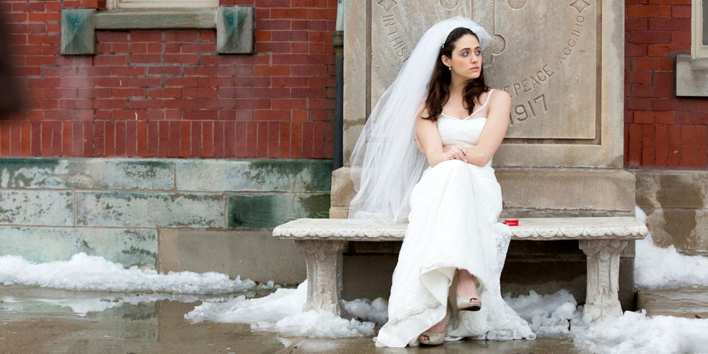 Fiona in her wedding dress sitting on a bench in Shameless