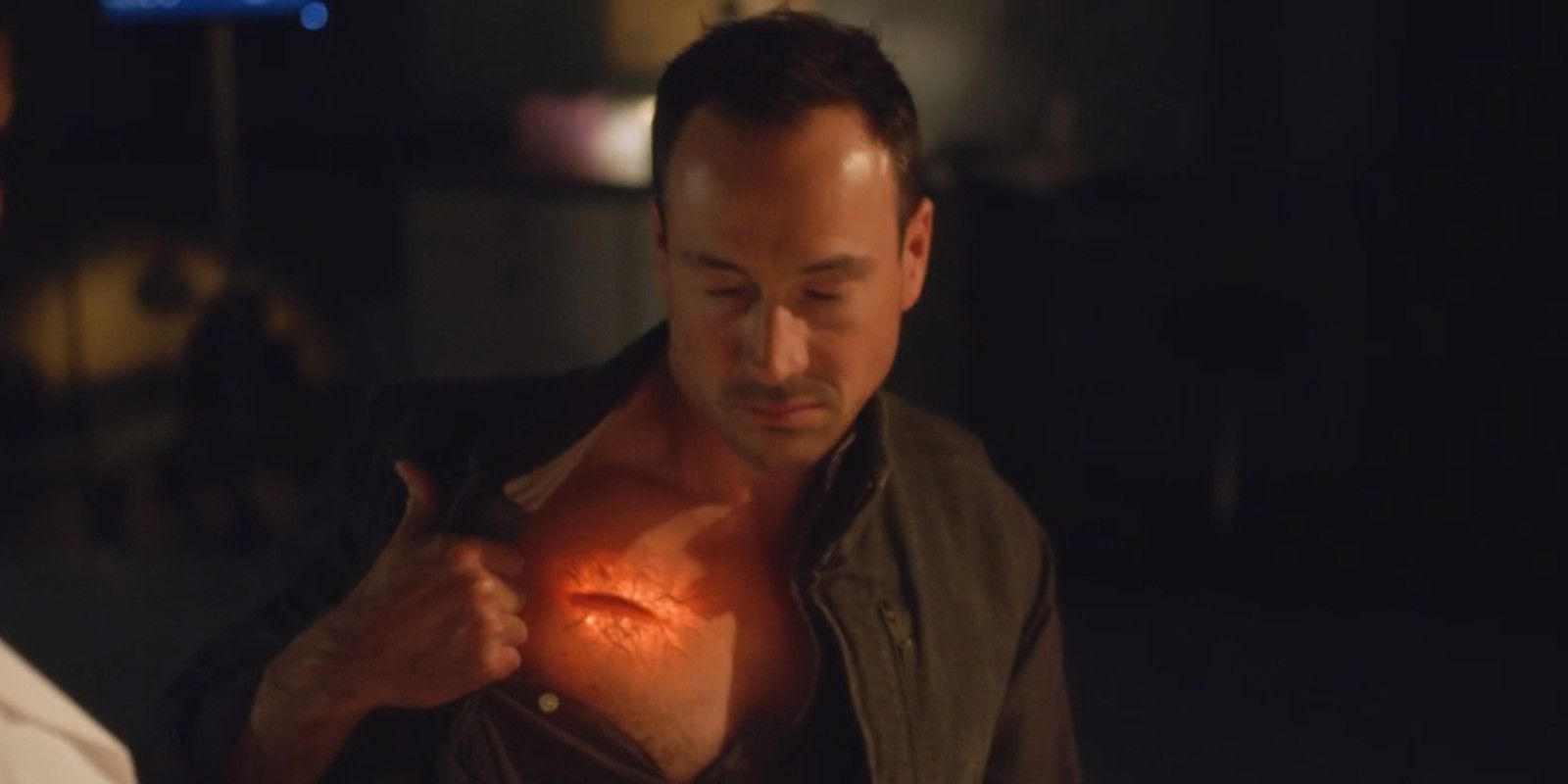 Cicada pulls back his shirt to reveal a wound in The Flash season 5