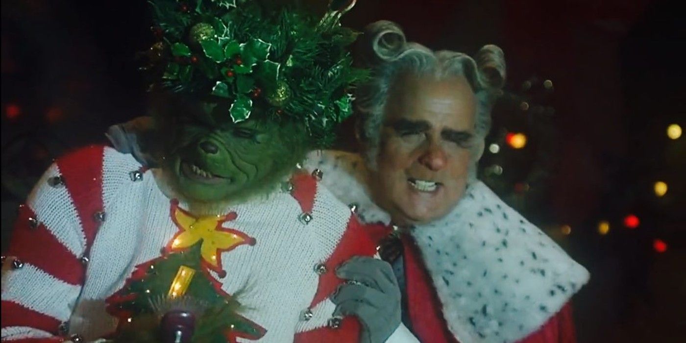The Mayor holds onto the Grinch in his Xmas sweater