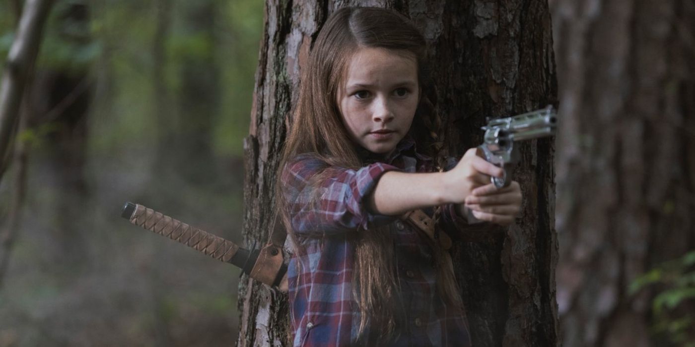 Judith Grimes na floresta segurando uma arma em The Walking Dead