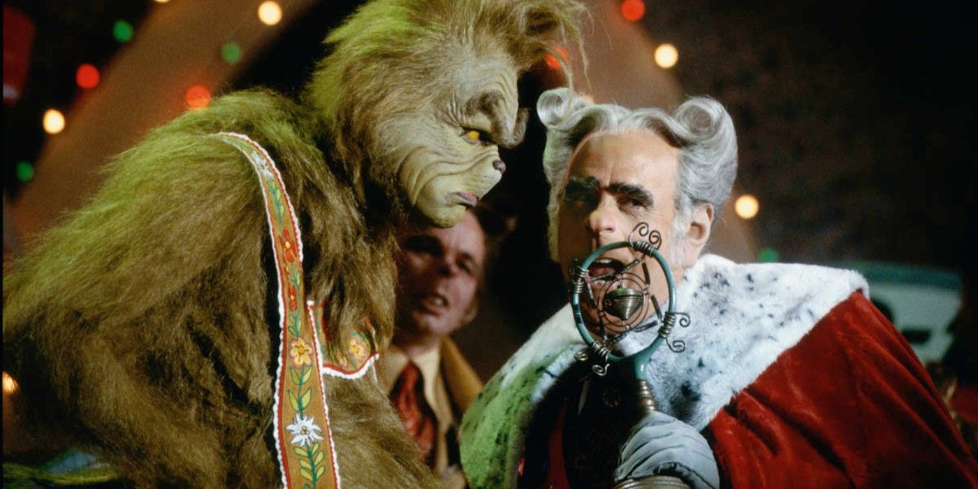 The Grinch and the mayor at a microphone