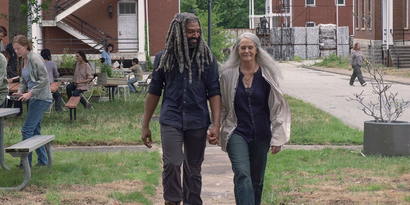 Ezekiel and Carol walk and hold hands in The Walking Dead
