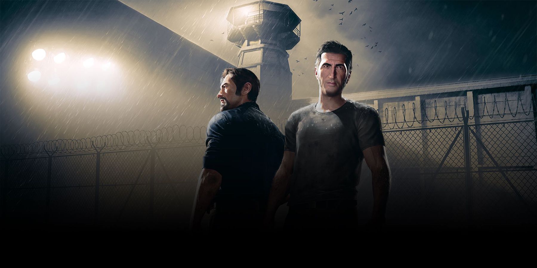The main characters of A Way Out stand in front of a prison guard tower
