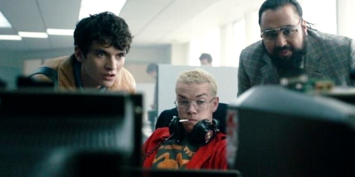 Stefan, Colin, and Mohan looking at a computer in Black Mirror Bandersnatch.
