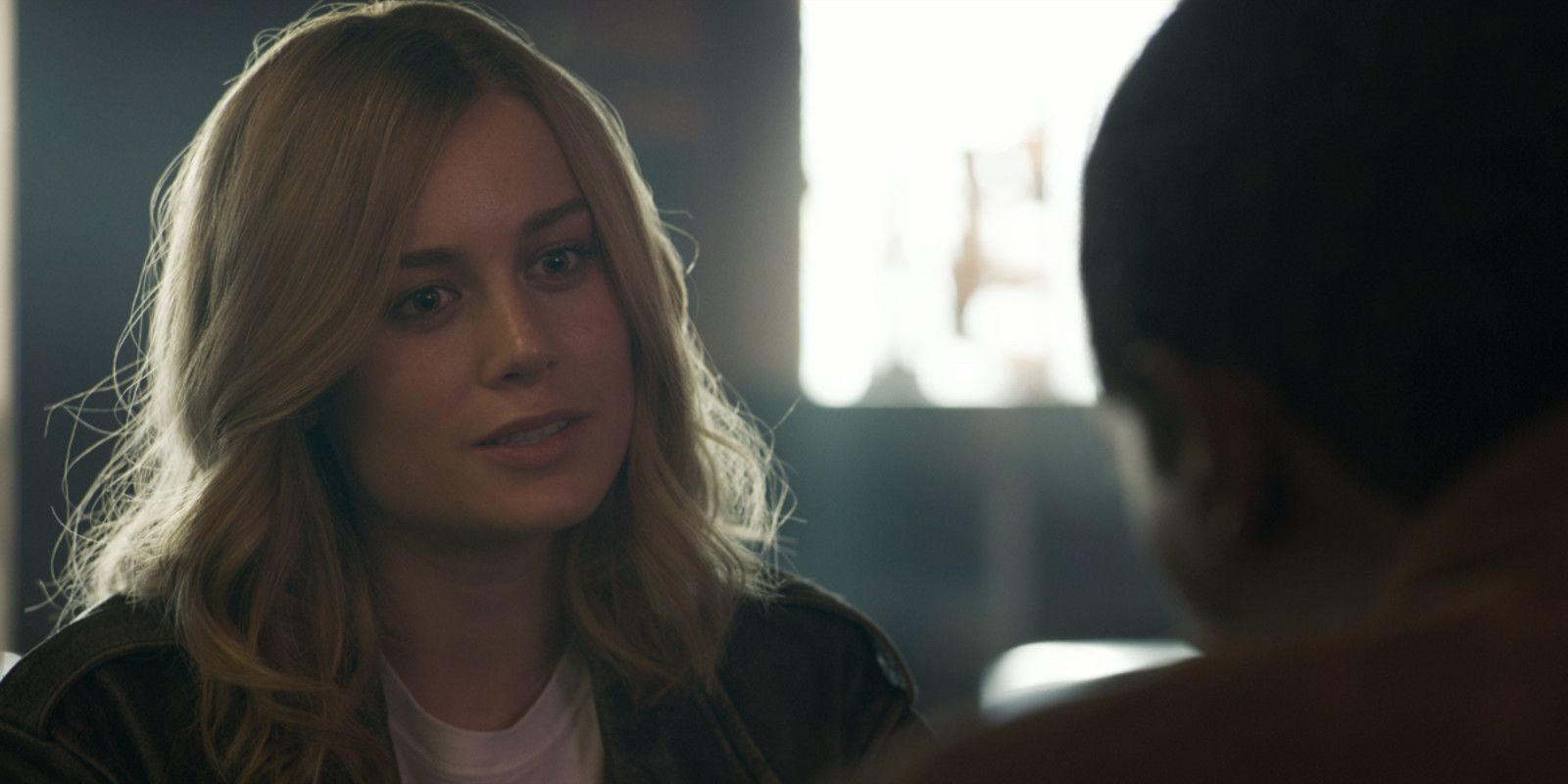 Captain Marvel smiles talking to Nick Fury