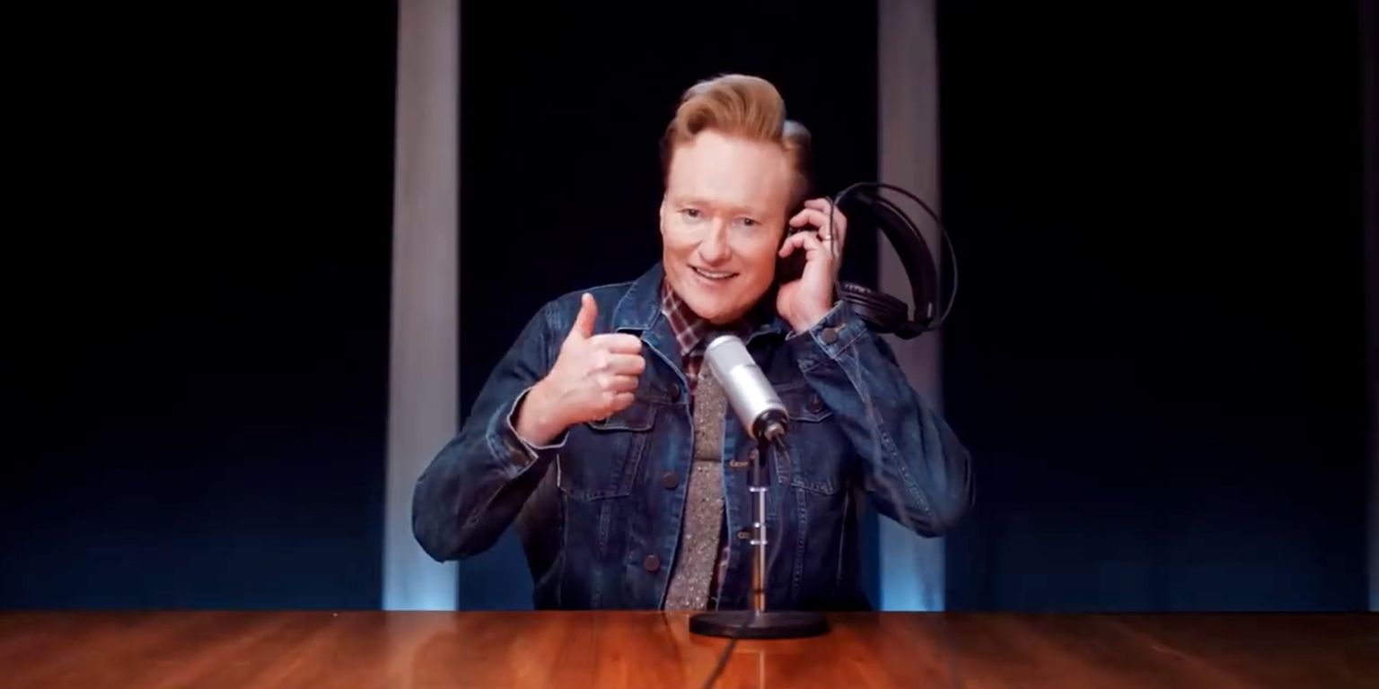 Conan O'Brien gives a thumbs up while hosting his podcast