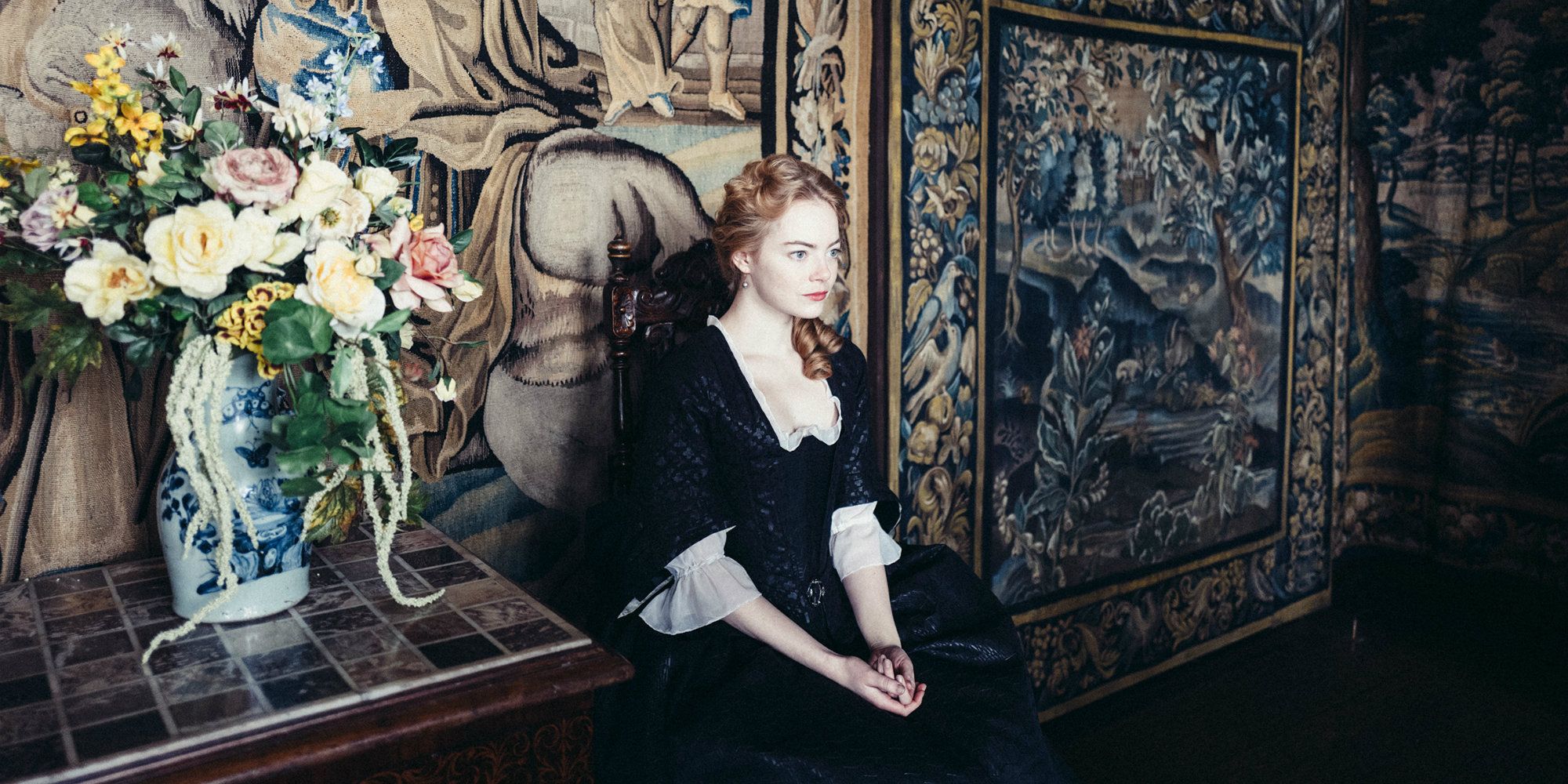 Abigail Masham sitting in a chair in The Favourite