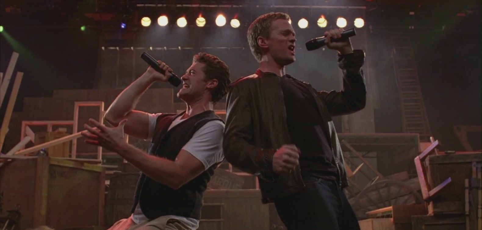Will and Bryan Ryan sining on stage in Glee
