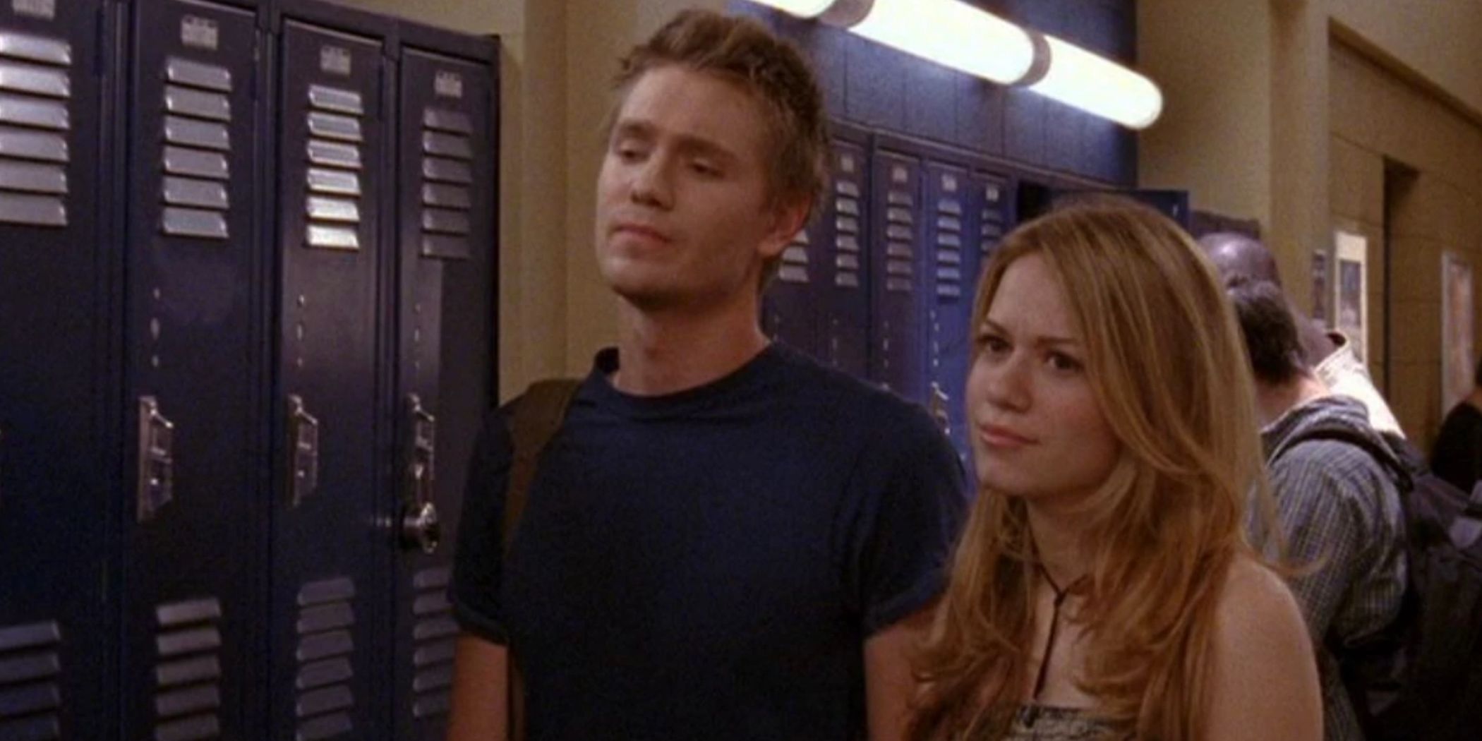 Lucas and Haley stand by a bank of lockers in One Tree Hill