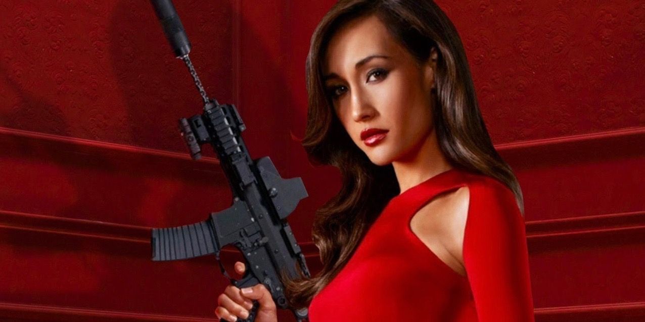 Maggie Q holds agun while wearing a red dress in Nikita