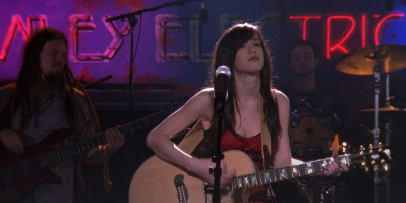 Mia angrily plays her guitar on stage in One Tree Hill