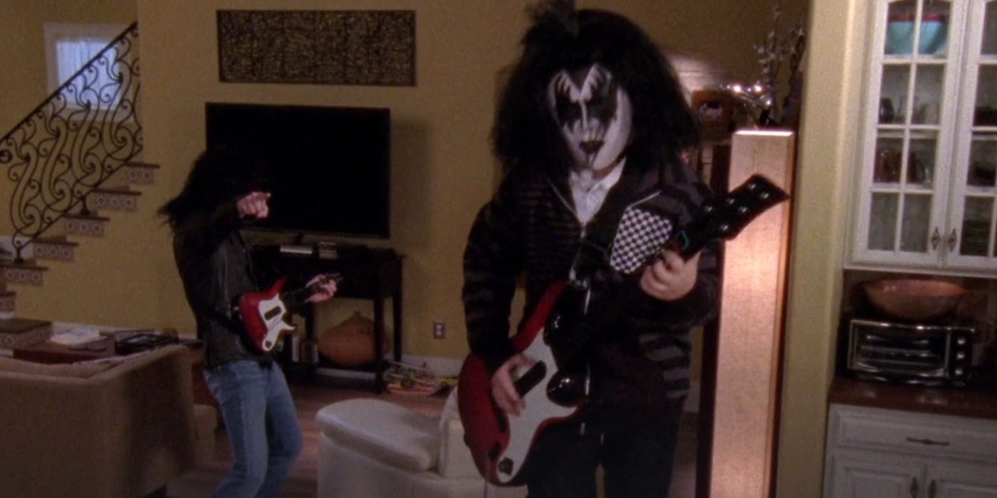 Nathan and Jamie play Rock Band guitars while dressed as members of KISS in One Tree Hill