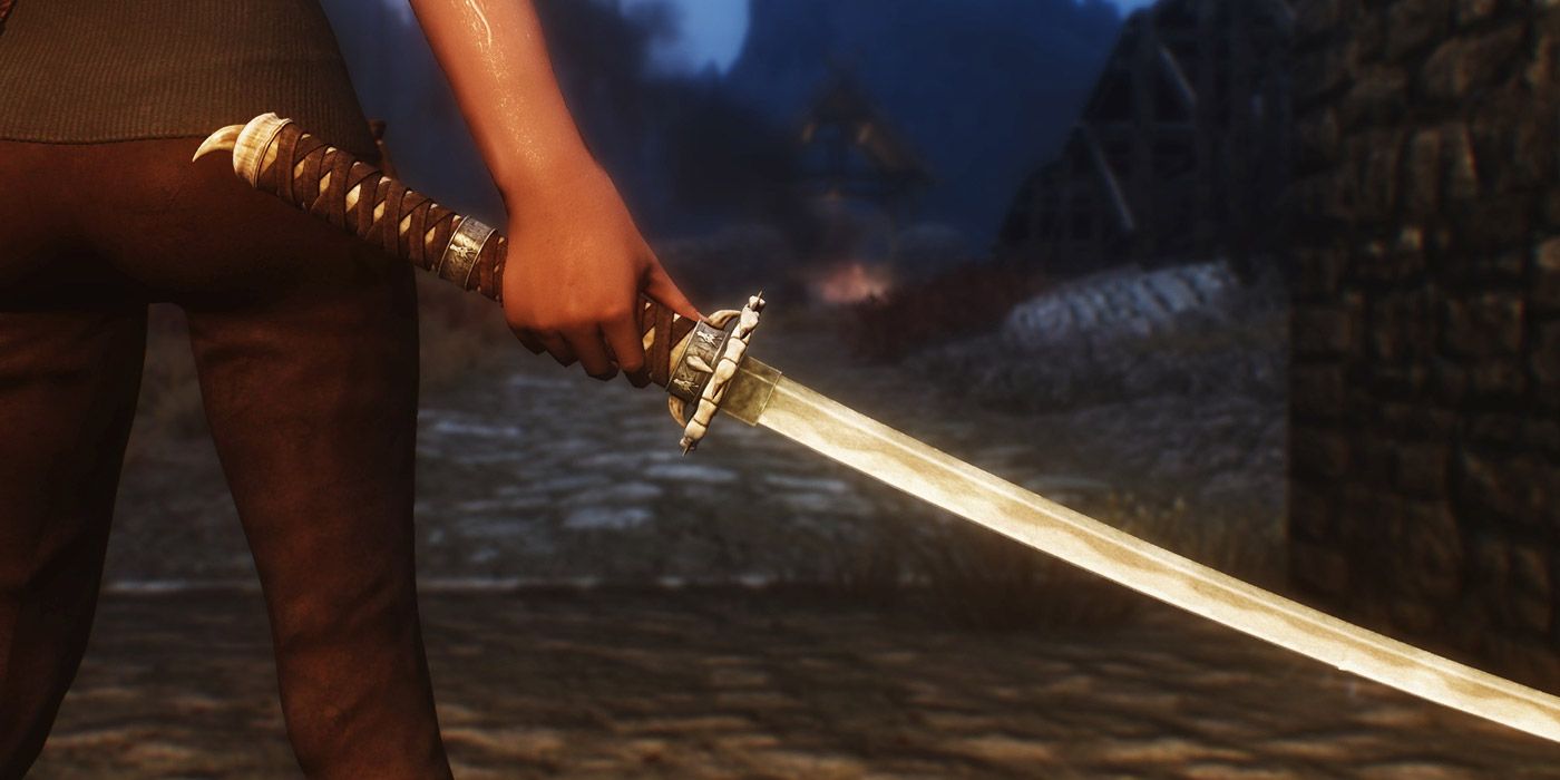 A girl holding a katana blade in Skyrim