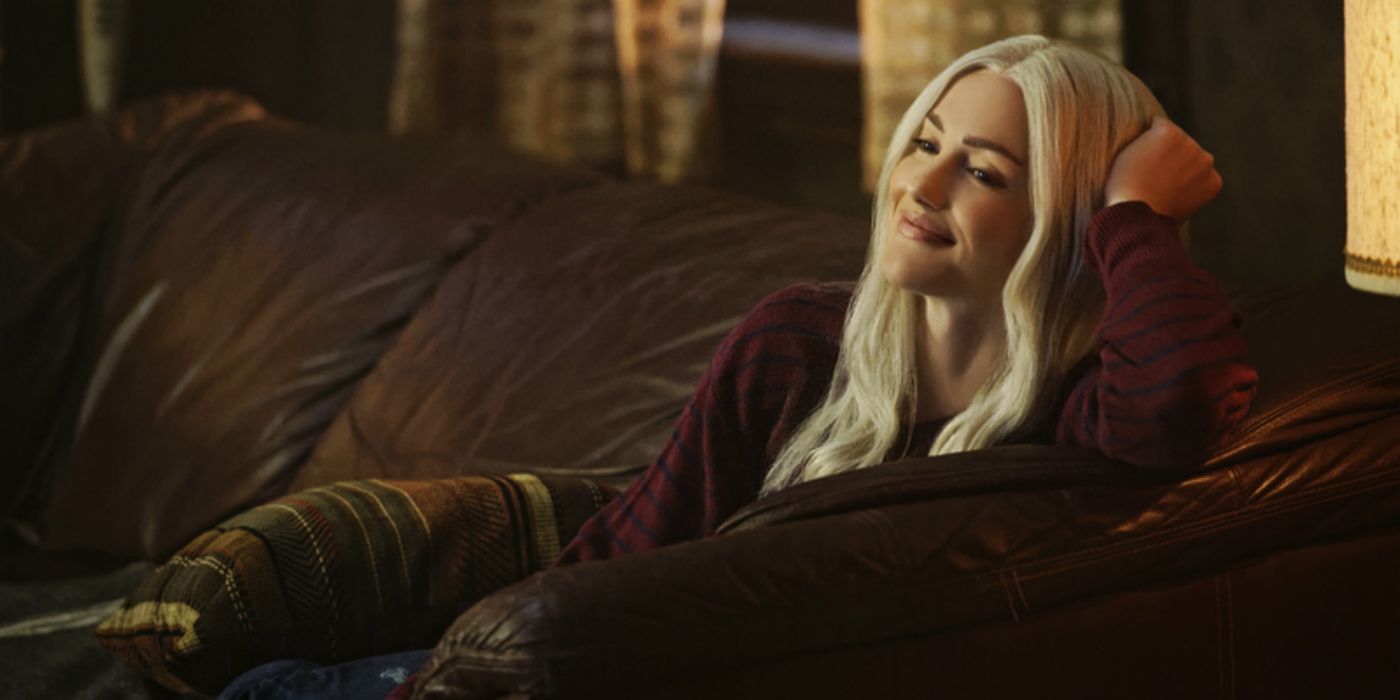 Dawn sits on the couch smiling in Titans
