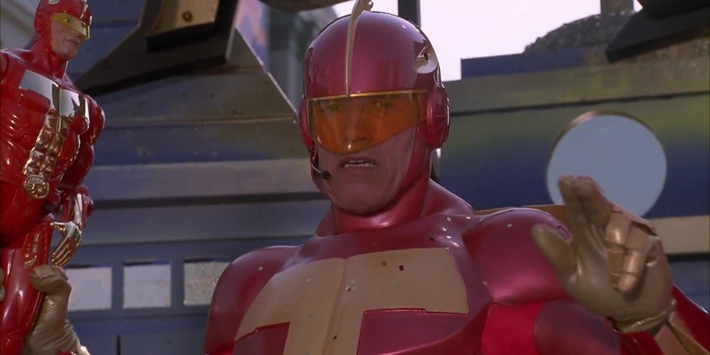 Turbo Man Holds a Turbo Man toy in Jingle All The Way