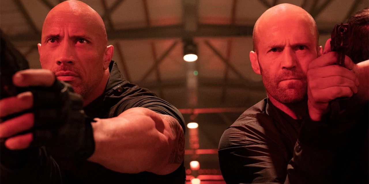 Hobbs e Shaw apontando armas na mesma direção em Hobbs & Shaw.