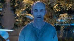 A grey vampire looks on in The Passage