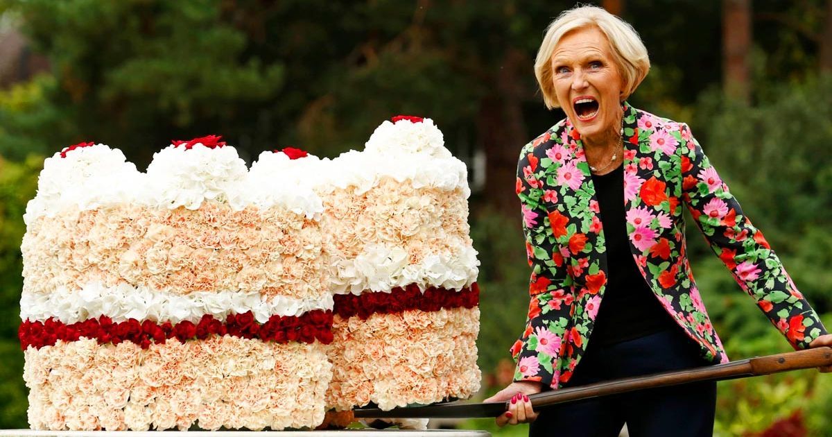 Mary Berry lifts a giant slice of cake with shovel