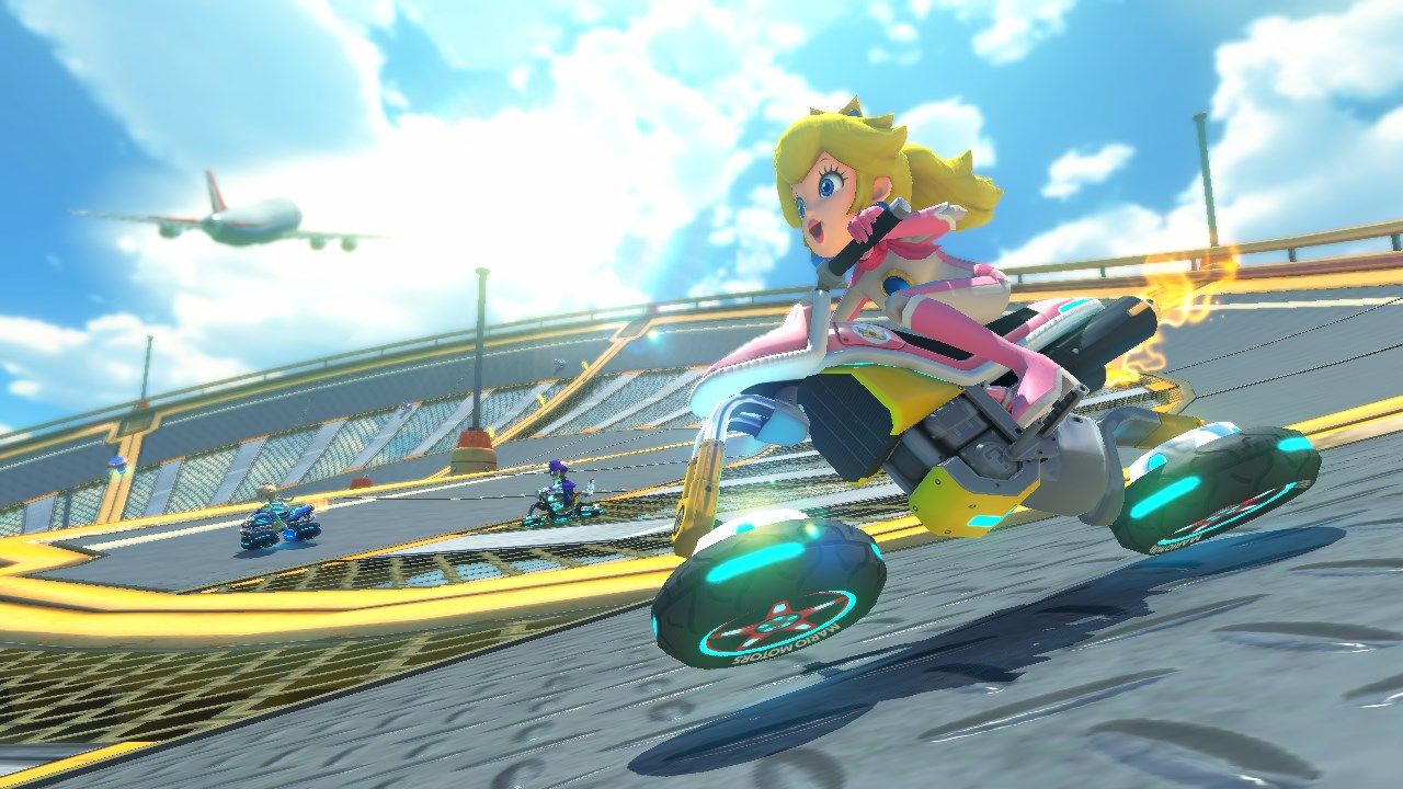 Princess Peach driving on a Mario Kart course