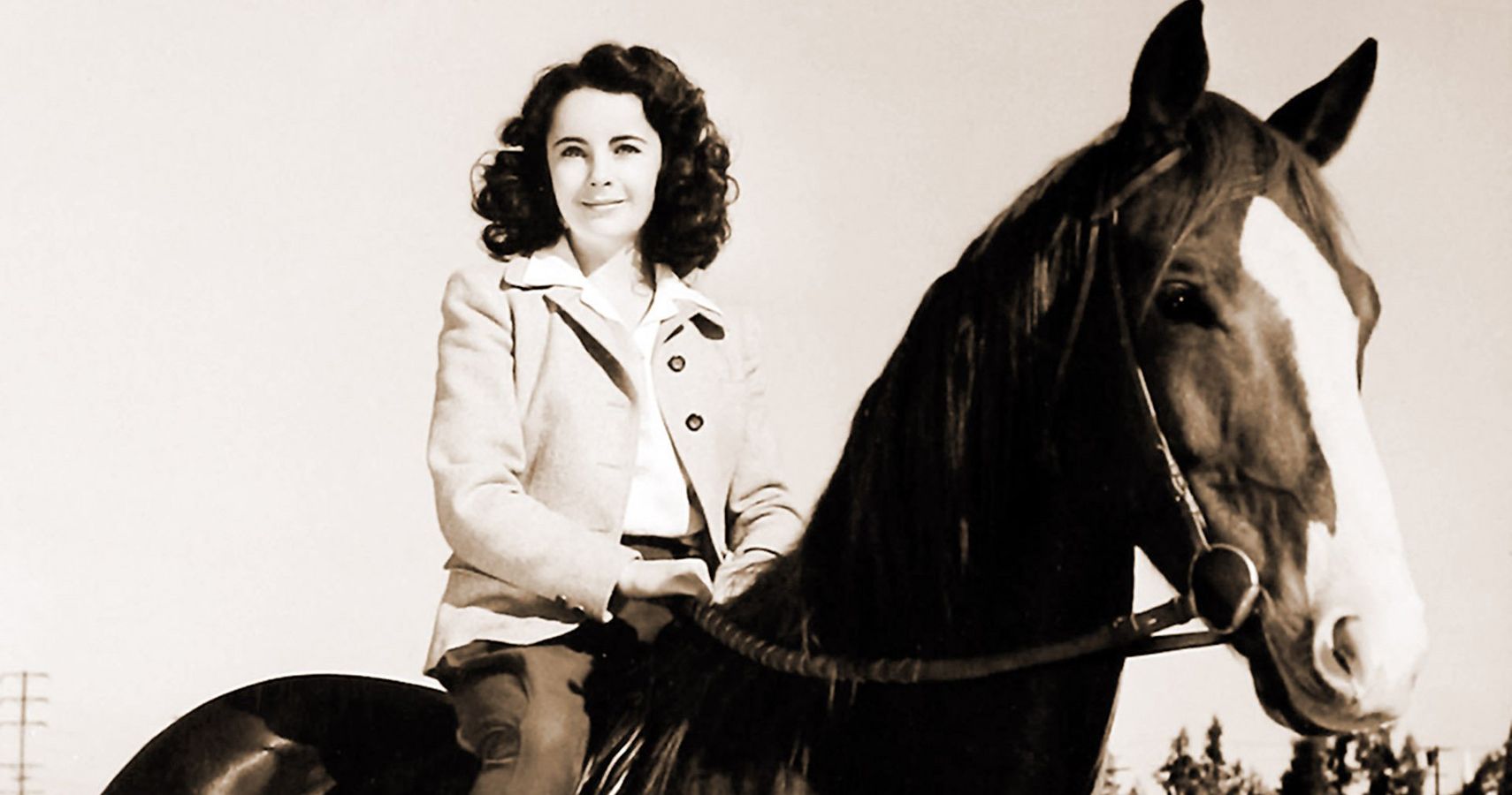A black and white image of a woman on her horse from the movie National Velvet 