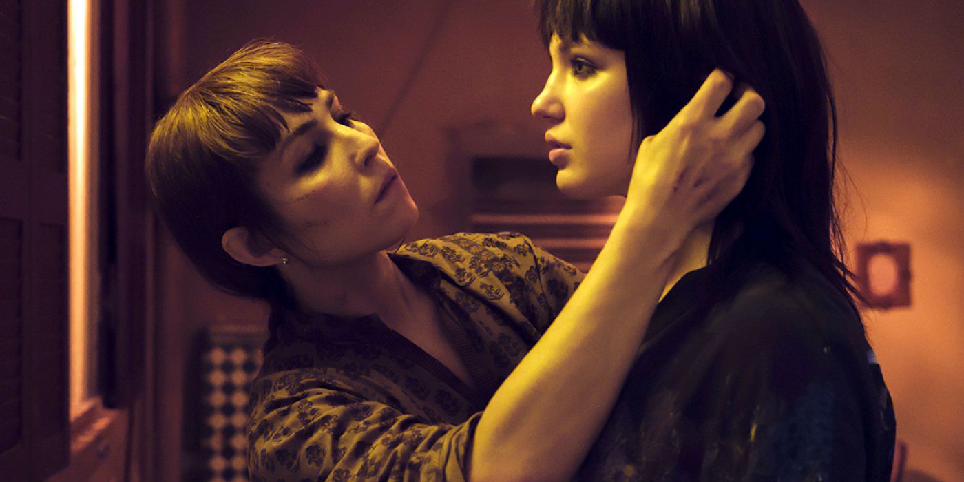 Noomi Rapace fixing a young girl's hair in Close
