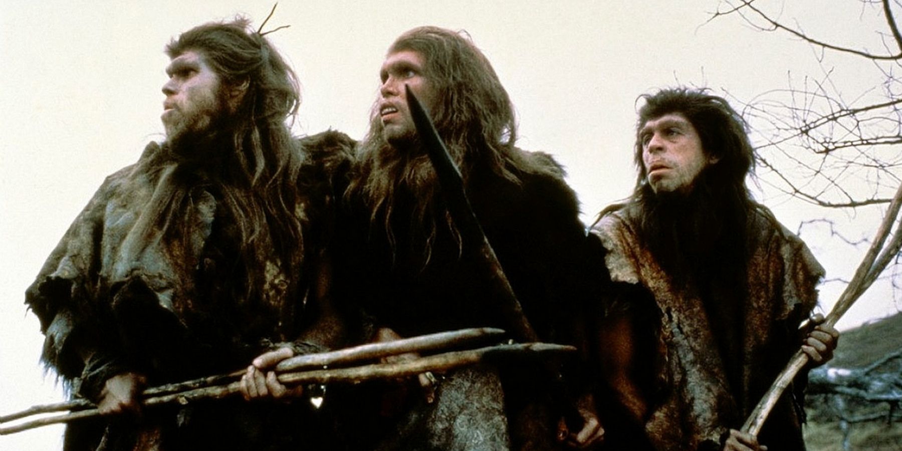 Cavemen holding sticks in Quest for Fire