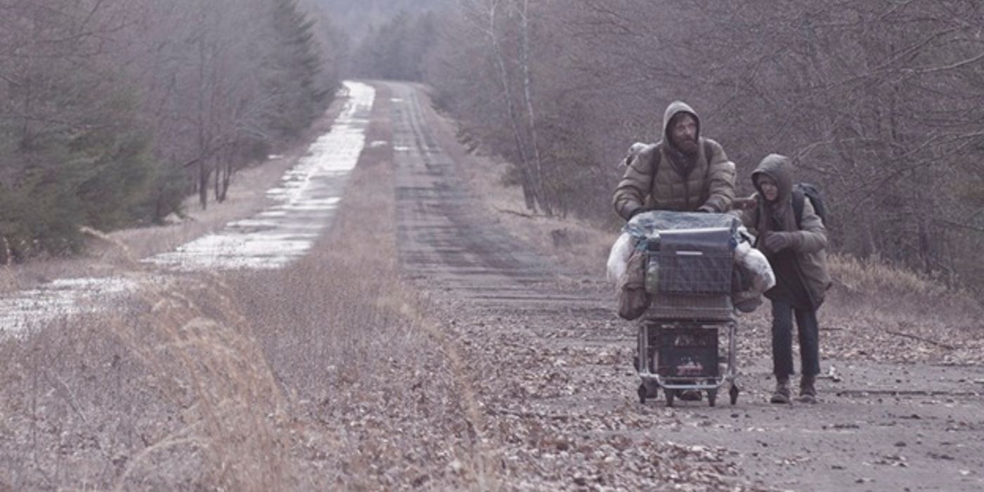 Viggo Mortensen and a child on the road in The Road