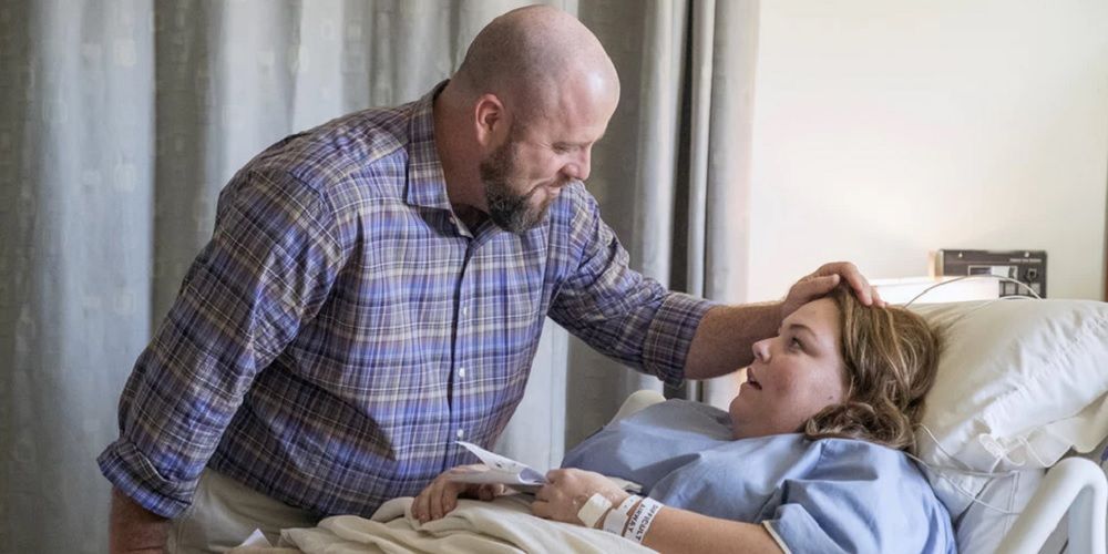 Toby touches Kate's forehead in the hospital in This Is Us