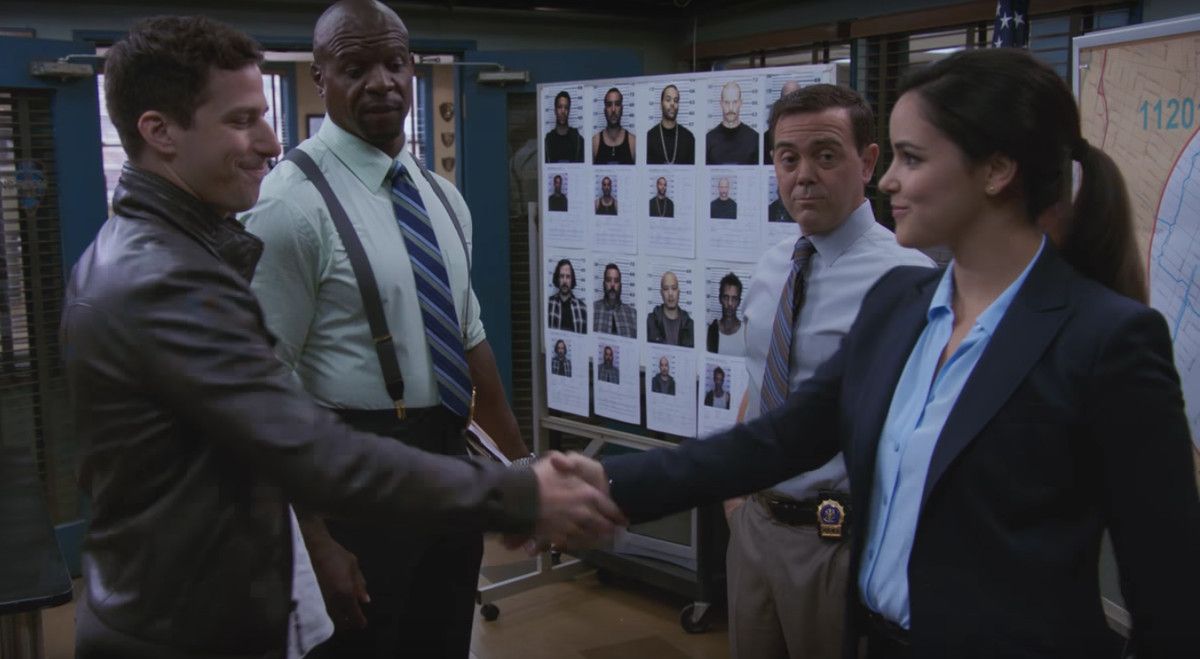 Jake and Amy shake hands in front of Terry and Boyle in Brooklyn Nine-Nine.