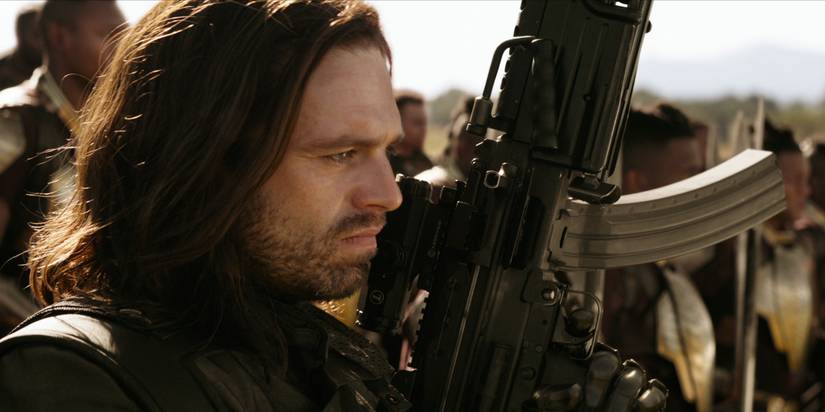 Bucky raising his gun in Wakanda and preparing to fight