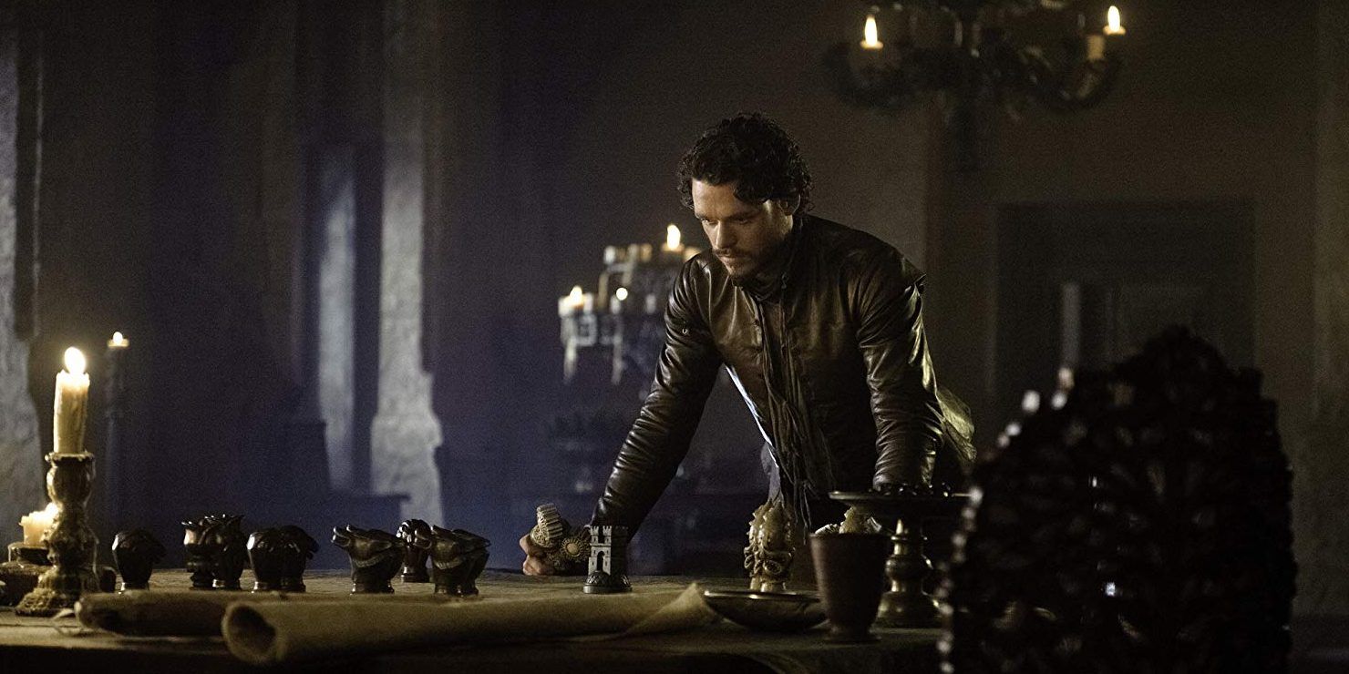 Robb leaning on the table in Game of Thrones