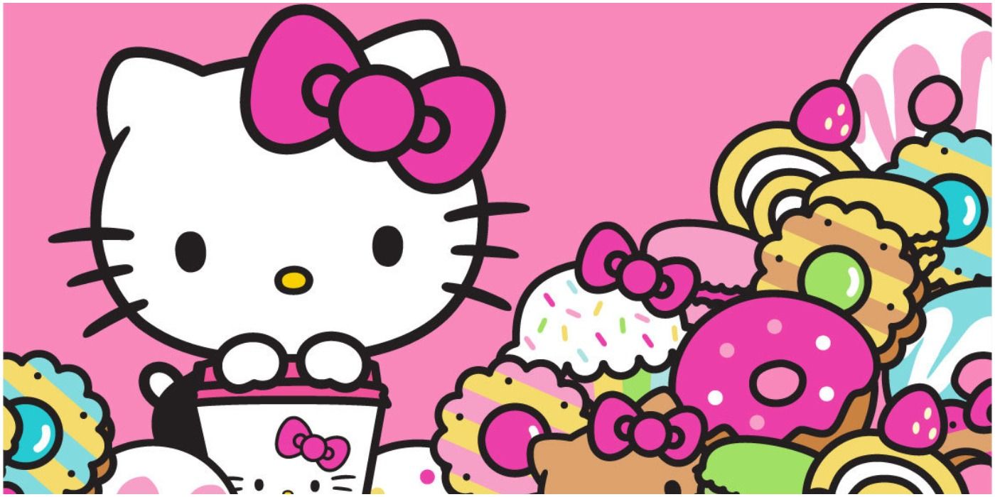 Hello Kitty standing next to a pile of sweet treats