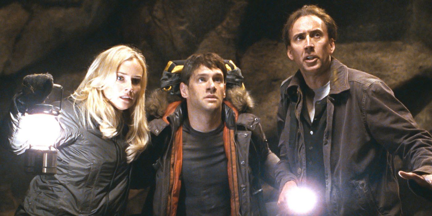 Nicolas Cage and Abigail with flashlights in a cave in National Treasure: Book of Secrets