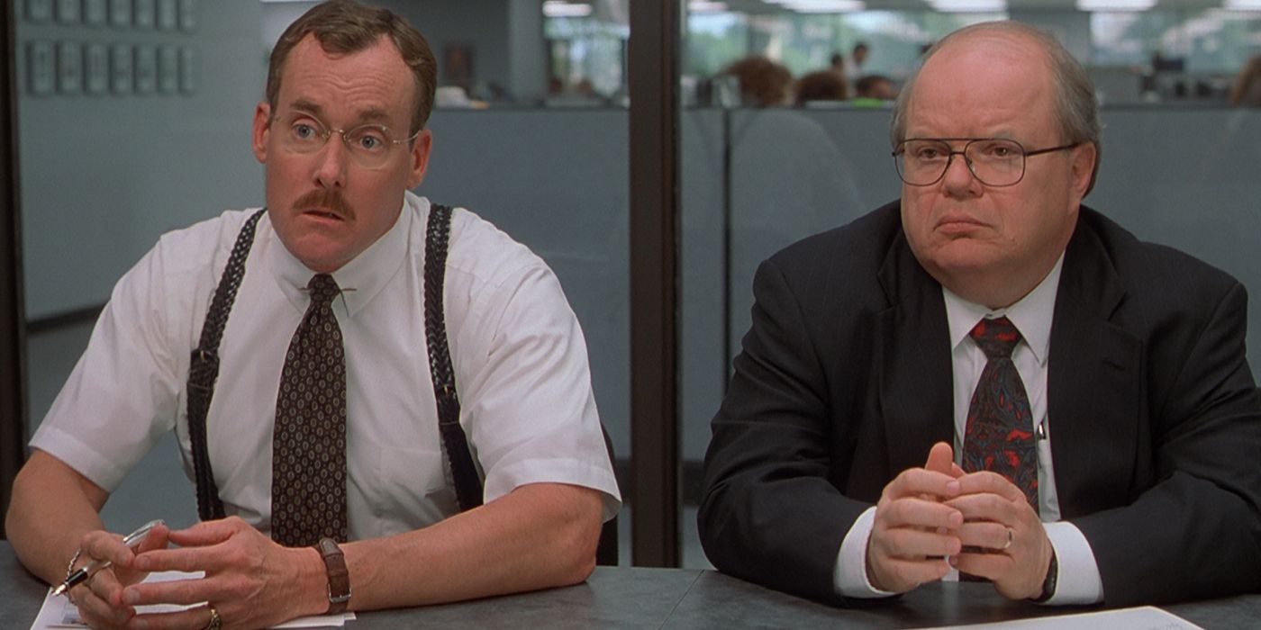 The Two Bobs sitting in the conference room in Office Space