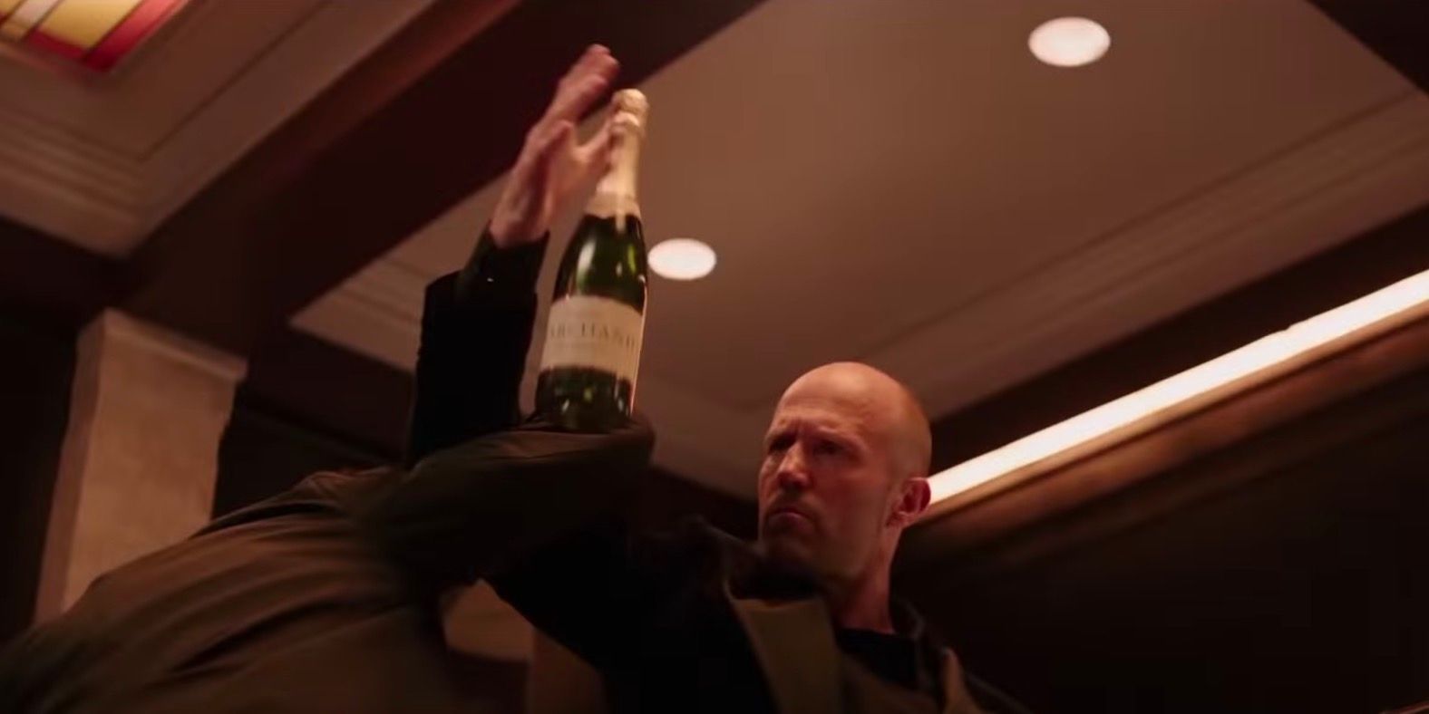 Shaw fighting with a champagne bottle in Hobbs and Shaw