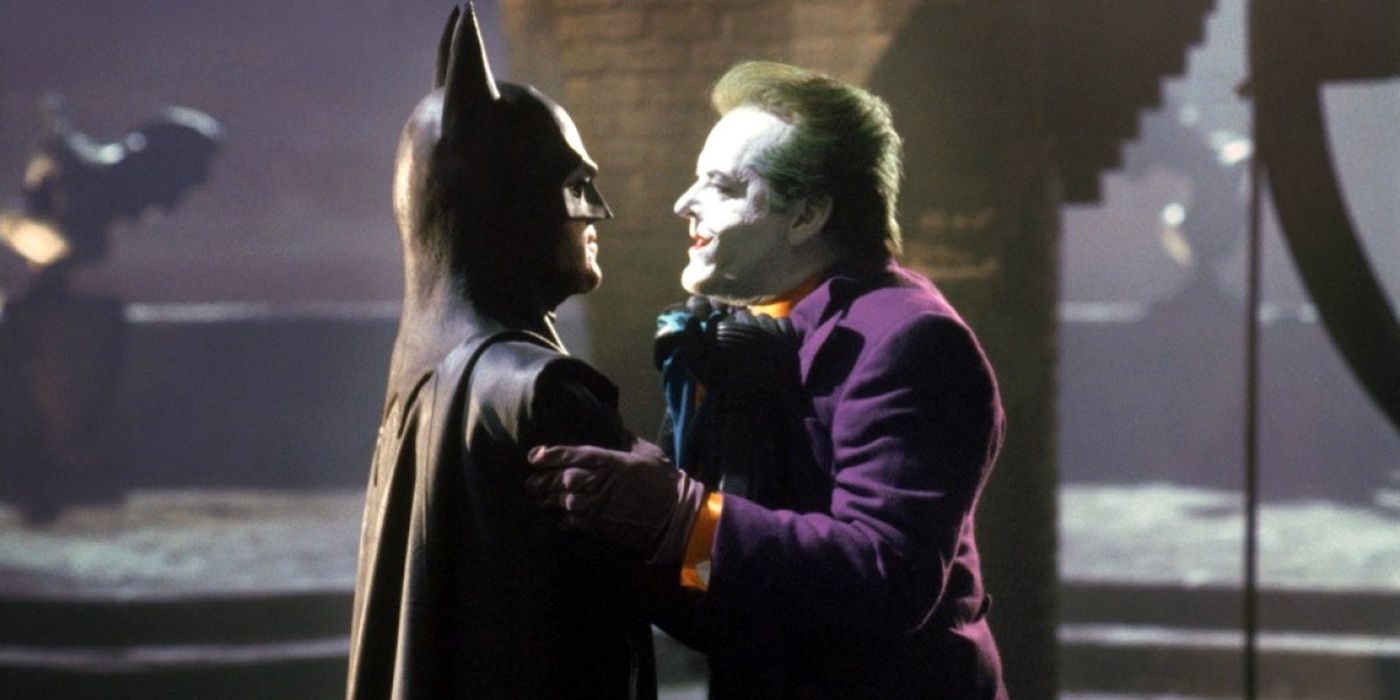 Batman (Michael Keaton) holding The Joker (Jack Nicholson) by the collar in Tim Burton's Batman