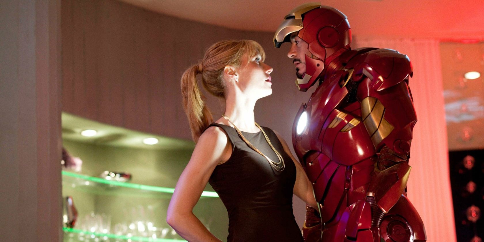 Tony Stark (Robert Downey Jr.) in his Iron Man suit talks to Pepper Potts (Gwyneth Paltrow) at his birthday party in Iron Man 2