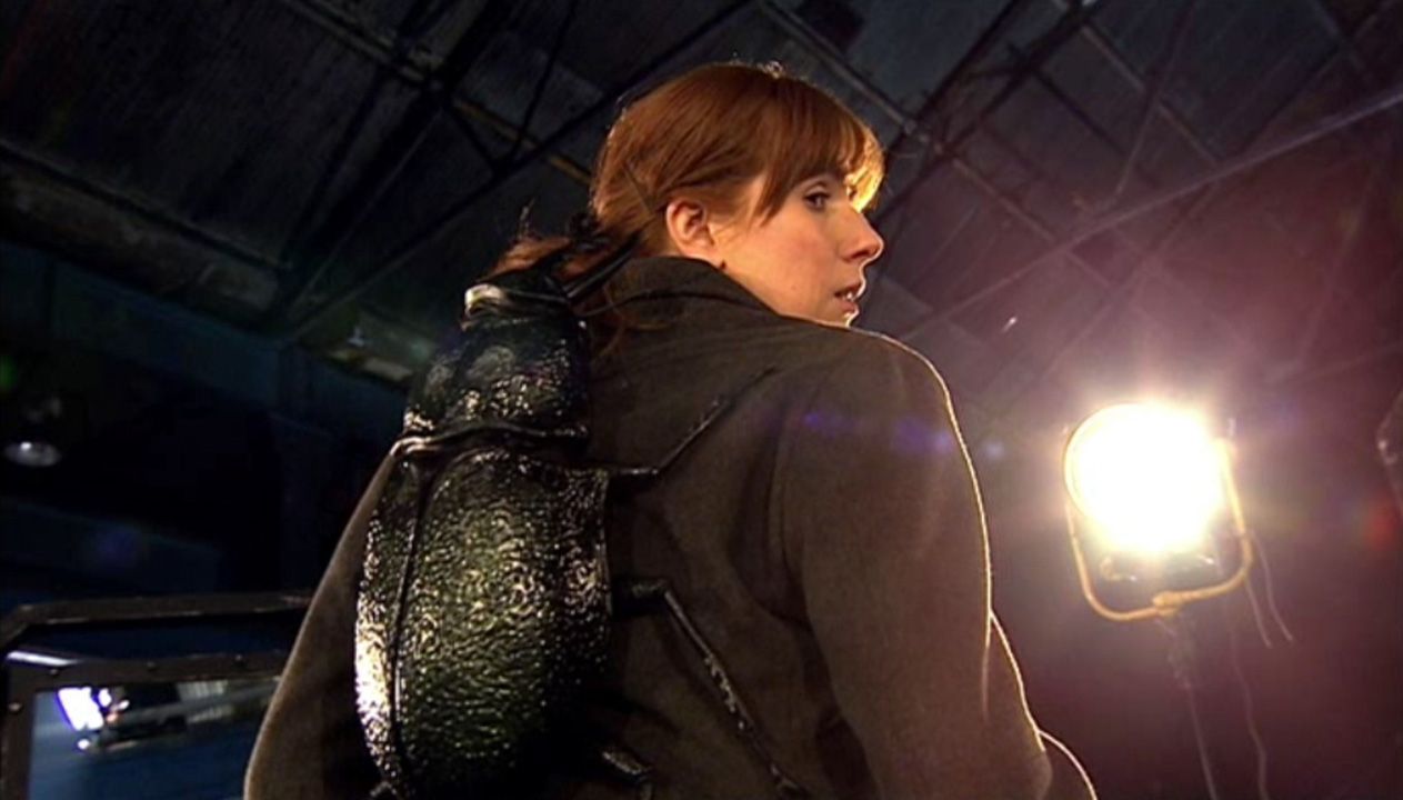 Donna Noble in Turn Left looking behind at the creature on her back