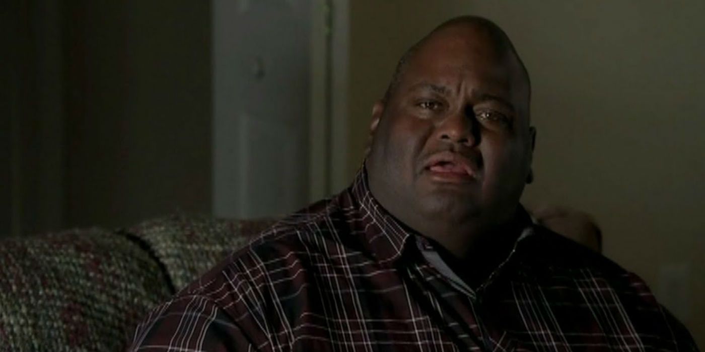 Huell denies knowing about Walt's money Breaking Bad, looking upset.