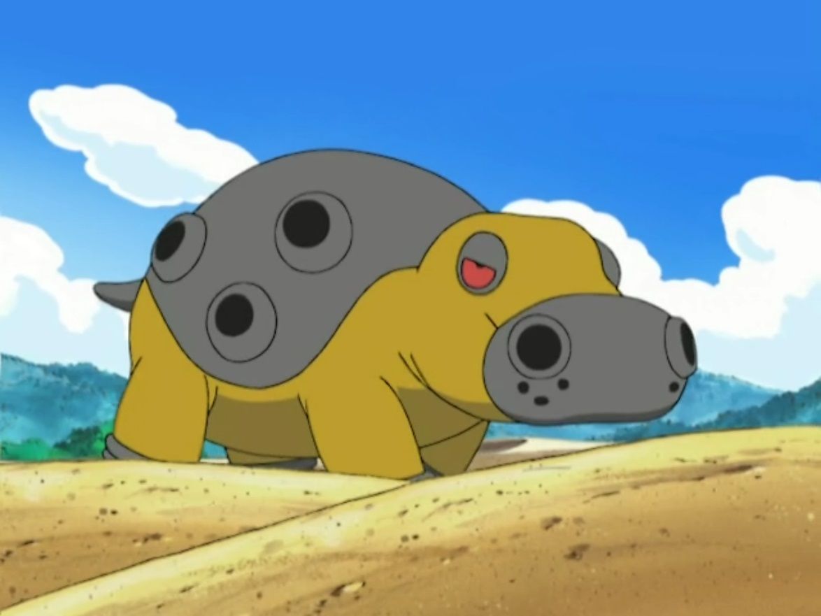 Hippowdon walks on sandy ground in front of a blue sky background in a scene from the Pokémon anime