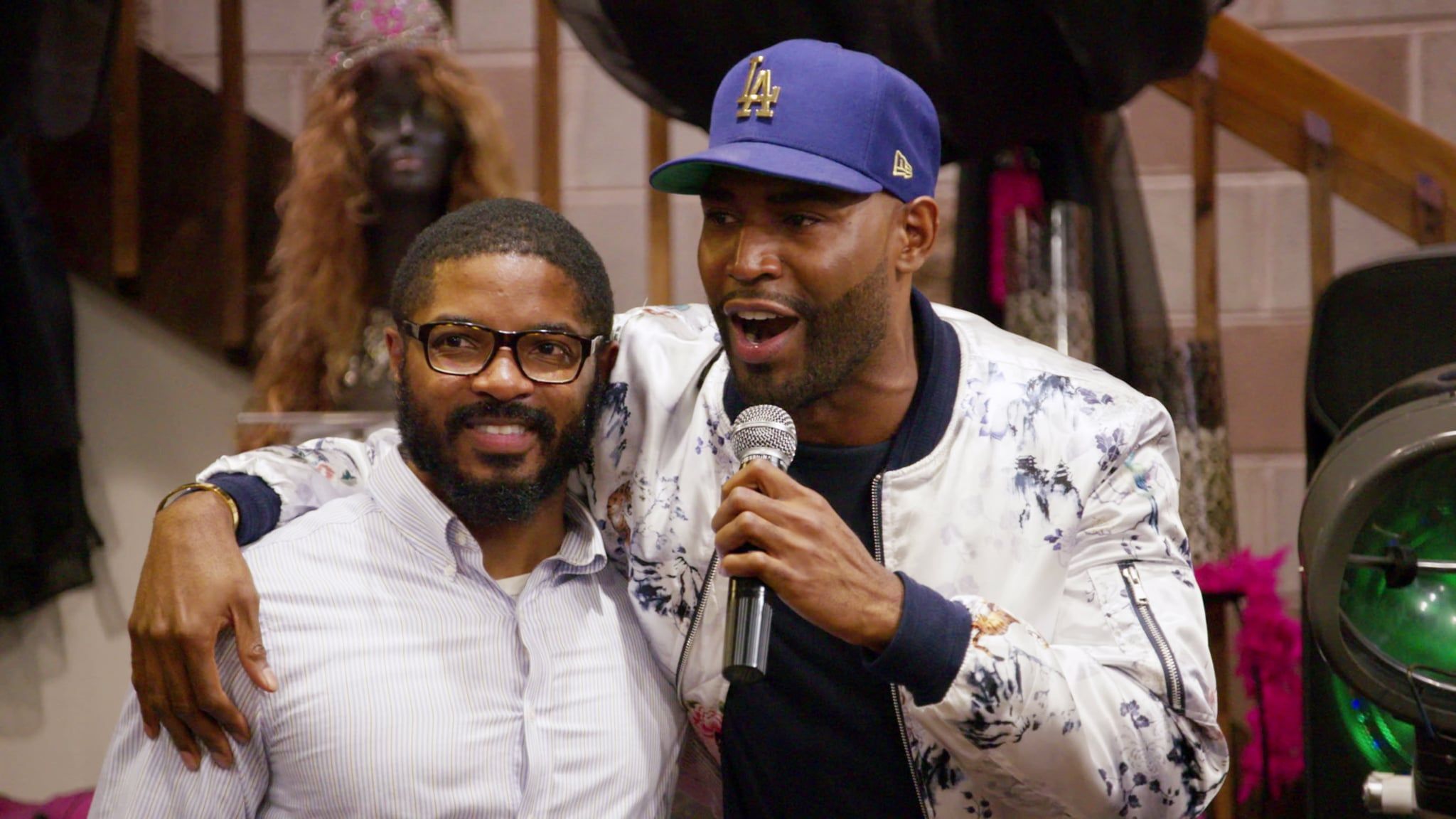 AJ Brown in Queer Eye Season 1 with Karamo who's holding microphone