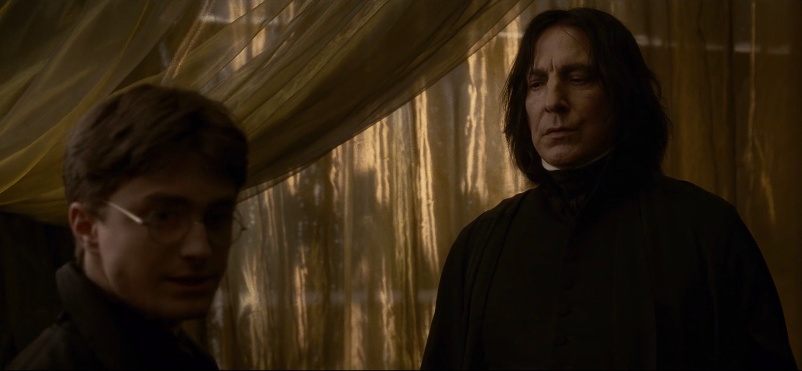 Alan Rickman as Snape and Daniel Radcliffe as Harry Potter
